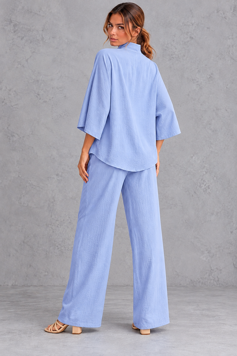 Women's blue turtleneck blouse and wide leg trouser co-ord set – back view