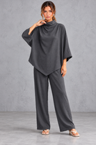 Women's dark grey turtleneck blouse and wide leg trouser co-ord set – front view with dipped hem