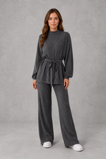 Women’s turtleneck knit two piece set with a belted long sleeve ribbed top and matching wide leg trousers for autumn and winter.