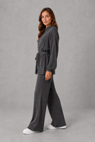 Women’s turtleneck knit two piece set with a belted long sleeve ribbed top and matching wide leg trousers for autumn and winter.