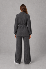 Women’s turtleneck knit two piece set with a belted long sleeve ribbed top and matching wide leg trousers for autumn and winter.