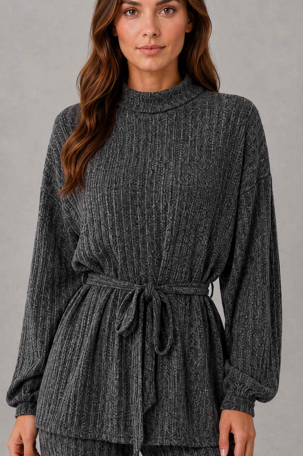 Women’s turtleneck knit two piece set with a belted long sleeve ribbed top and matching wide leg trousers for autumn and winter.