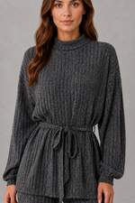 Women’s turtleneck knit two piece set with a belted long sleeve ribbed top and matching wide leg trousers for autumn and winter.