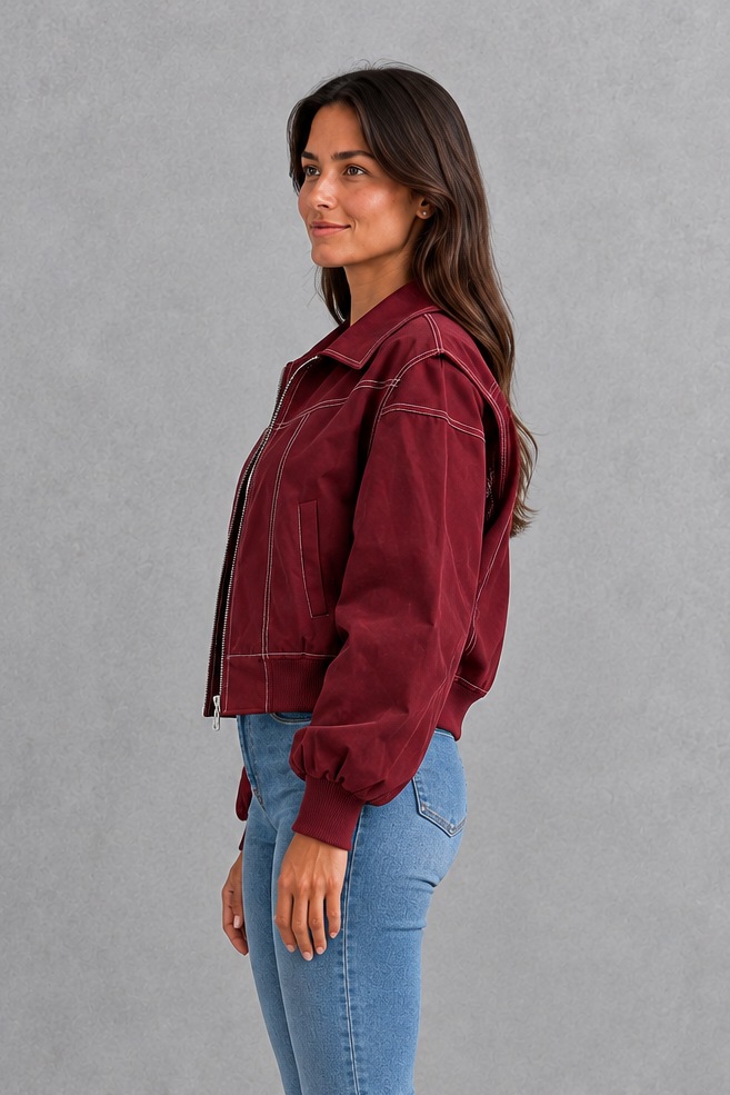 Women’s vegan leather zip jacket with white contrast stitching, a tailored silhouette and sleek structured finish for contemporary styling.