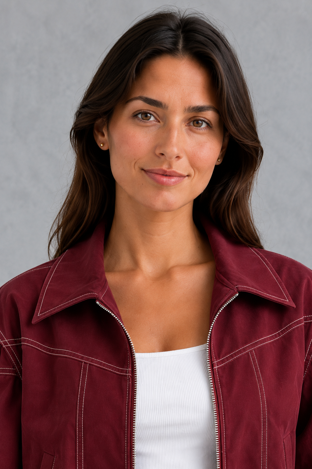 Women’s vegan leather zip jacket with white contrast stitching, a tailored silhouette and sleek structured finish for contemporary styling.