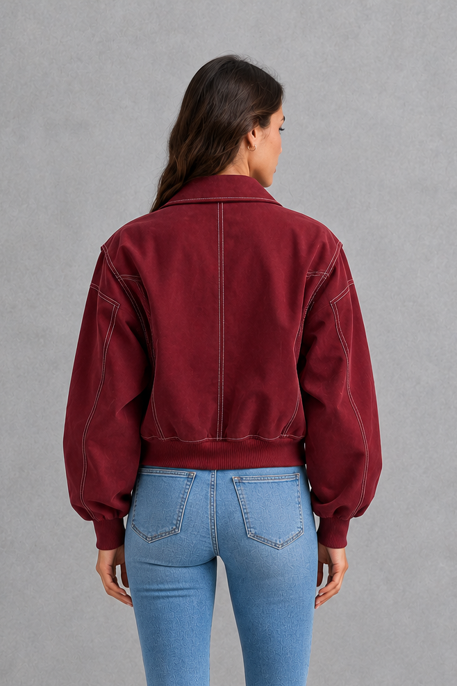 Women’s vegan leather zip jacket with white contrast stitching, a tailored silhouette and sleek structured finish for contemporary styling.