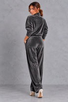 Women's dark grey velvet high neck top and wide leg trouser set – back view