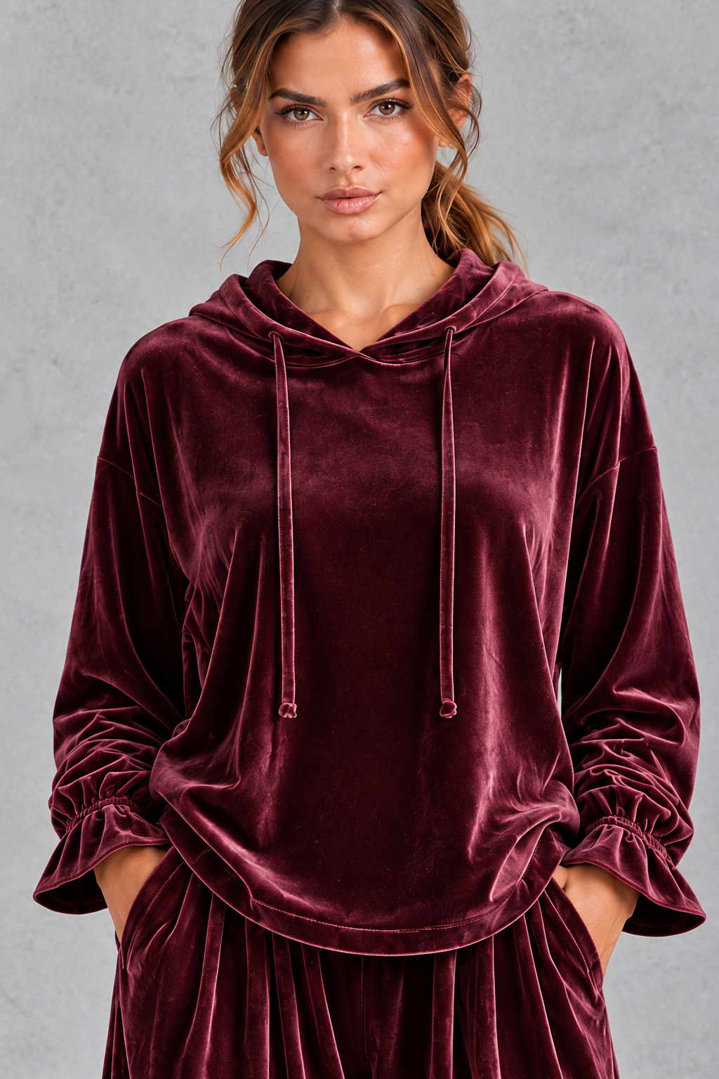 Women's burgundy velvet hoodie – close-up of drawstring hood and ruffle cuffs