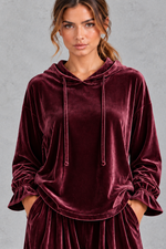 Women's burgundy velvet hoodie – close-up of drawstring hood and ruffle cuffs