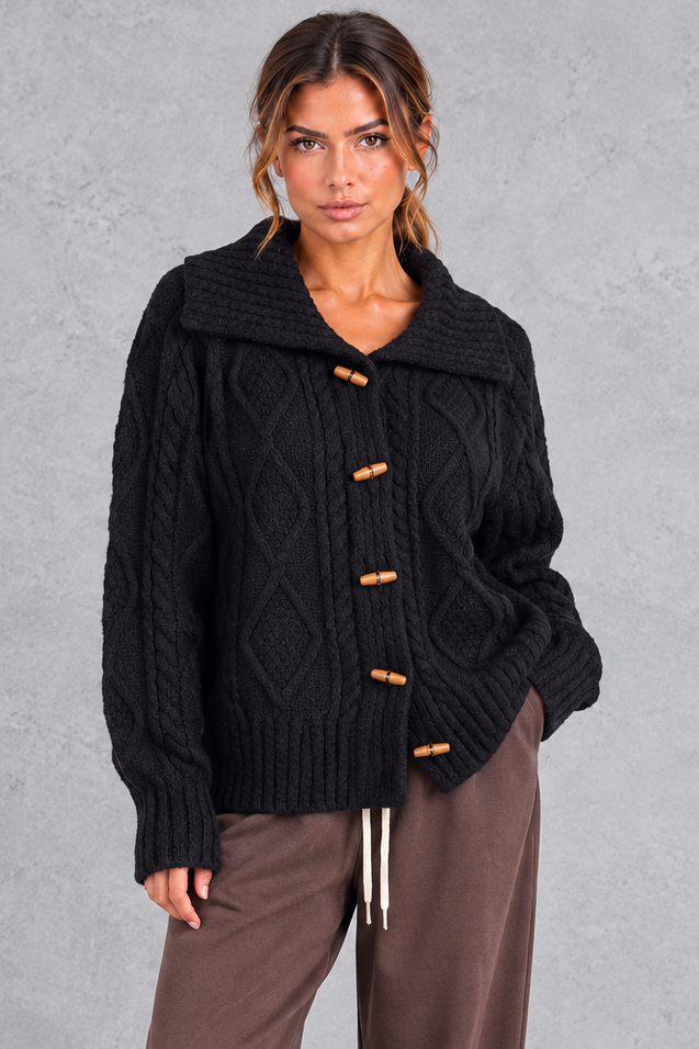 Women's black chunky cable knit cardigan with wide collar – front view
