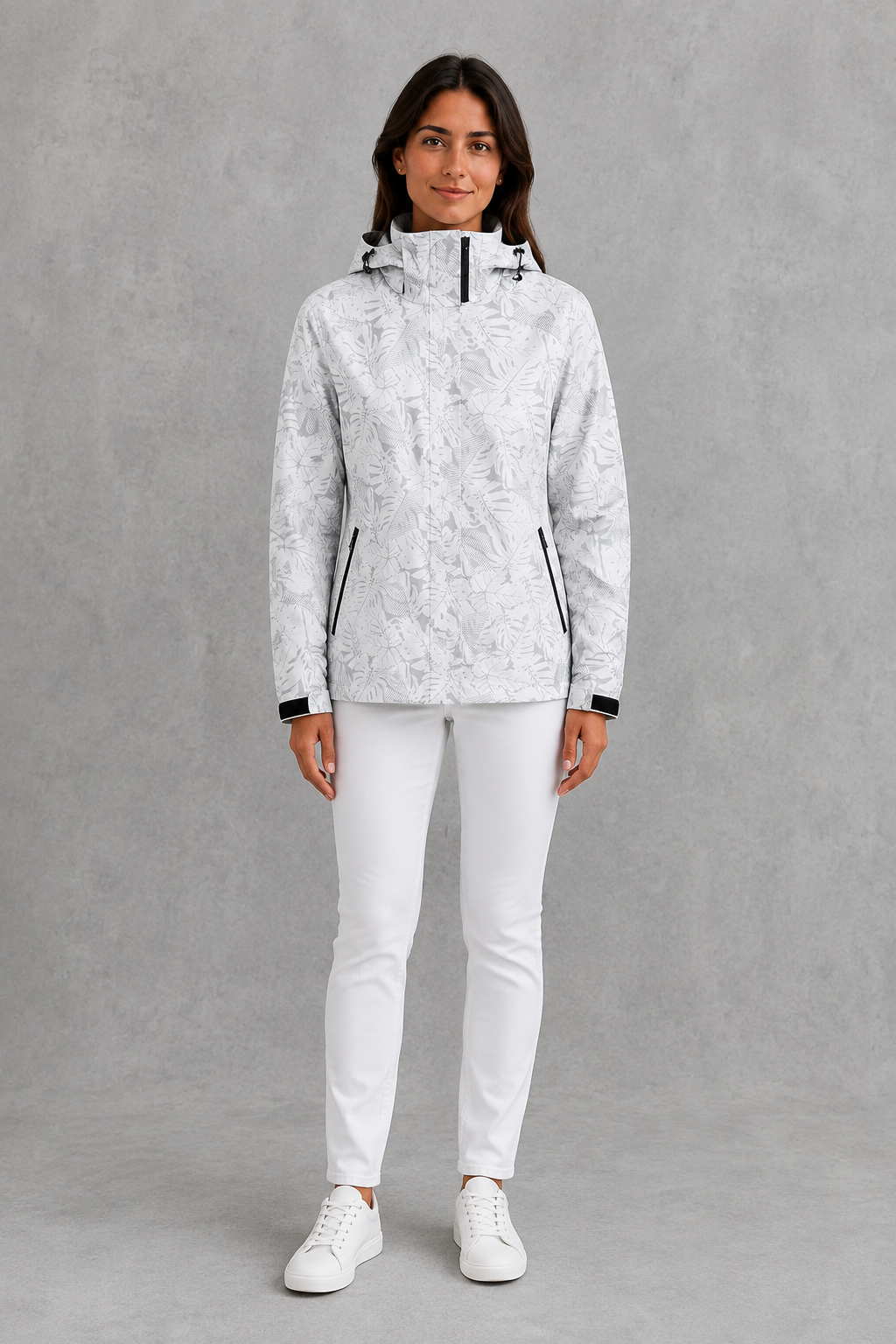 Women’s waterproof leaf print jacket with a protective hood, adjustable drawstring waist and lightweight design for rainy and changeable weather.