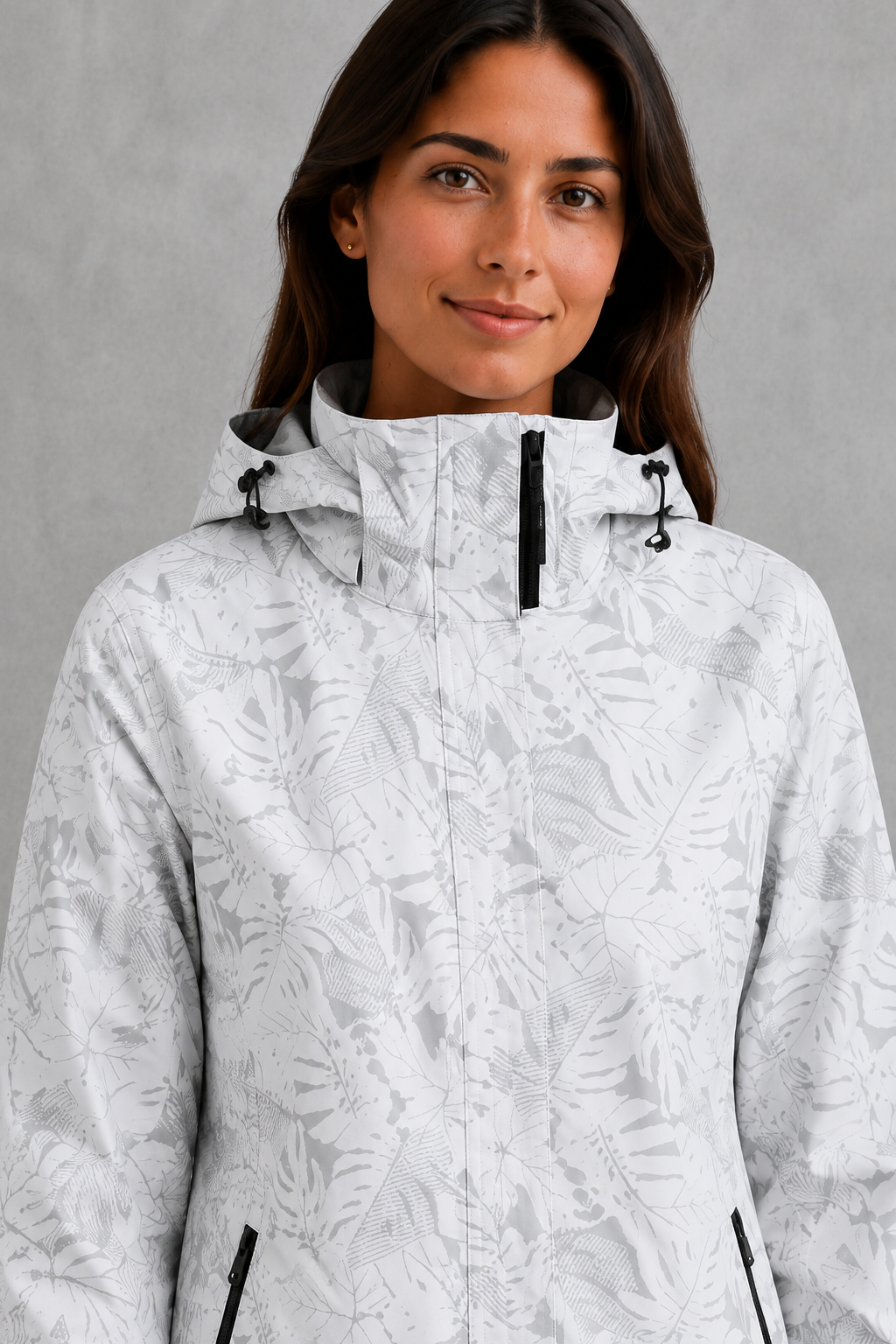 Women’s waterproof leaf print jacket with a protective hood, adjustable drawstring waist and lightweight design for rainy and changeable weather.