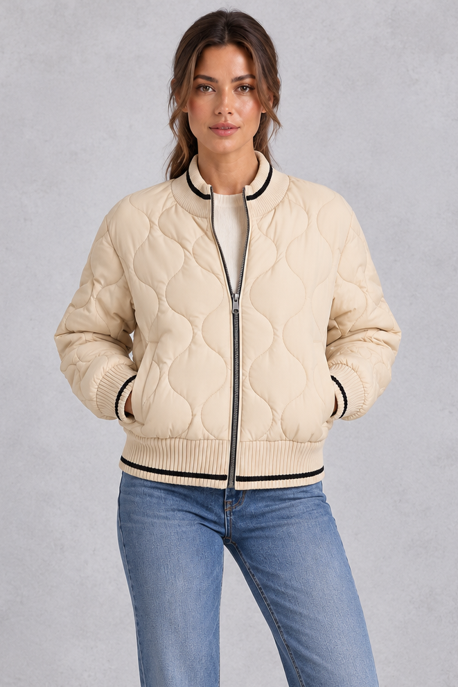 Women’s quilted bomber jacket with wave-stitch detailing, a high ribbed collar, full zip front, extended cuffs and contrast trims.