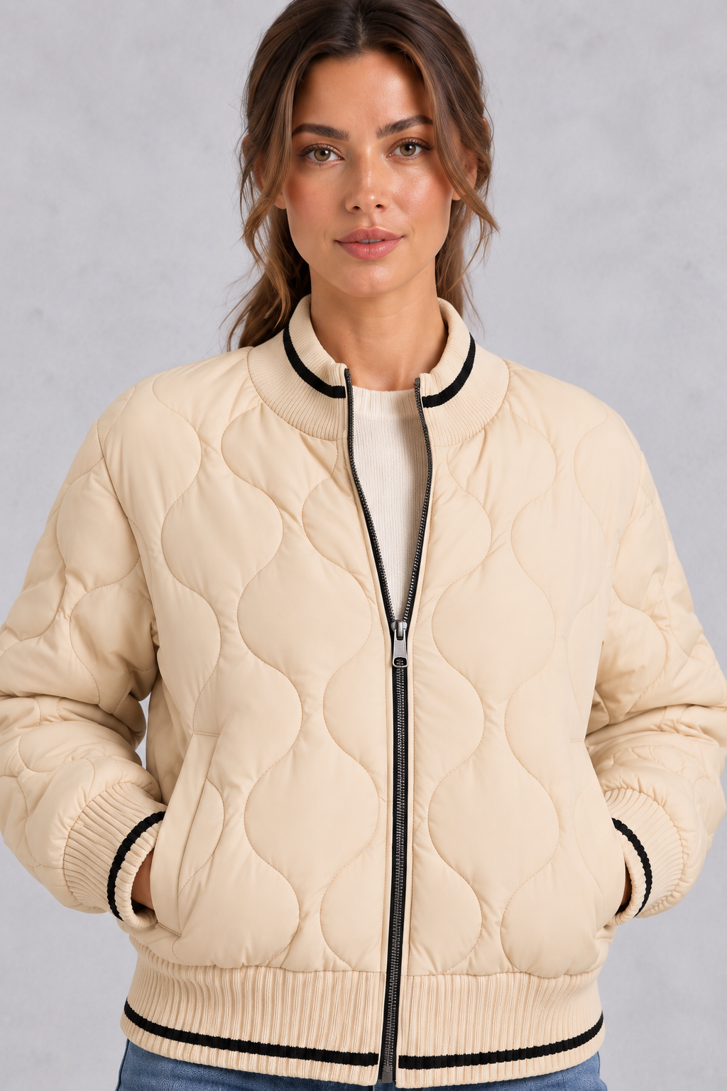 Women’s quilted bomber jacket with wave-stitch detailing, a high ribbed collar, full zip front, extended cuffs and contrast trims.