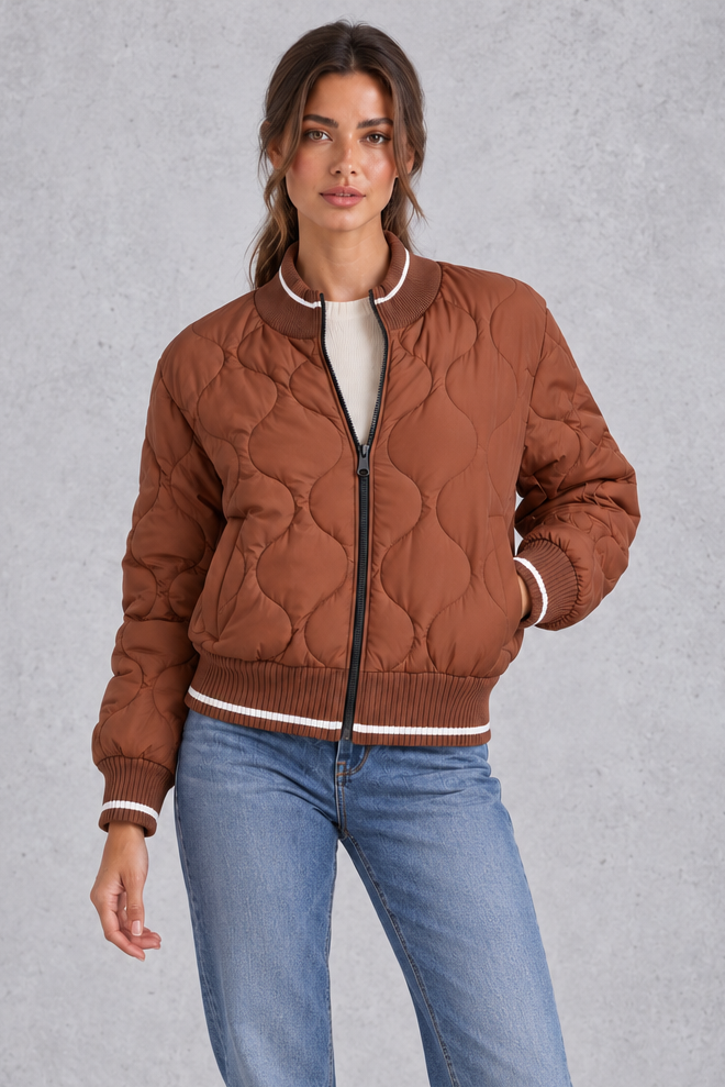 Women’s quilted bomber jacket with wave-stitch detailing, a high ribbed collar, full zip front, extended cuffs and contrast trims.