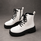 Women’s white embroidered ankle boots with a smooth PU leather upper, decorative embroidery, chunky platform heels and a structured combat-inspired silhouette.