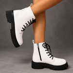 Women’s white embroidered ankle boots with a smooth PU leather upper, decorative embroidery, chunky platform heels and a structured combat-inspired silhouette.