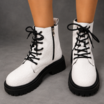 Women’s white embroidered ankle boots with a smooth PU leather upper, decorative embroidery, chunky platform heels and a structured combat-inspired silhouette.