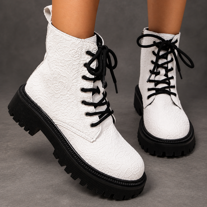 Women’s white embroidered ankle boots with a smooth PU leather upper, decorative embroidery, chunky platform heels and a structured combat-inspired silhouette.