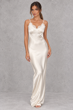 Women’s white satin-look lace maxi dress with V-neckline, slender shoulder straps, delicate lace patchwork and statement backless design.