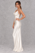 Women’s white satin-look lace maxi dress with V-neckline, slender shoulder straps, delicate lace patchwork and statement backless design.