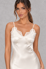 Women’s white satin-look lace maxi dress with V-neckline, slender shoulder straps, delicate lace patchwork and statement backless design.
