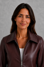 Women’s wine leather-look jacket with a tailored silhouette and front zip fastening, styled as an elegant biker-inspired autumn jacket.