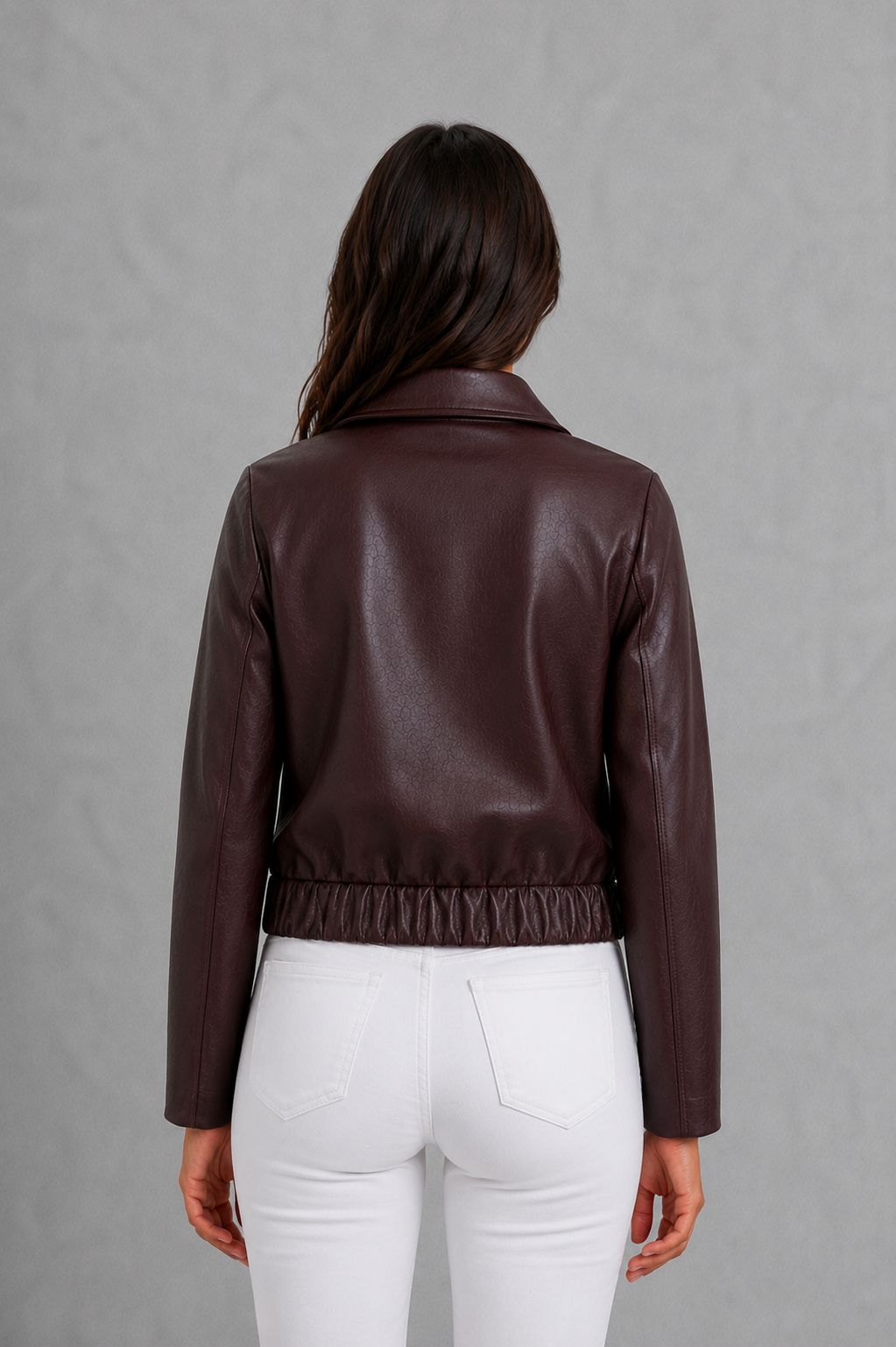 Women’s wine leather-look jacket with a tailored silhouette and front zip fastening, styled as an elegant biker-inspired autumn jacket.