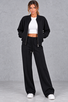 Women's zip-up jacket & trousers set in Black – front view
