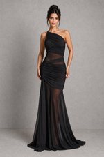 Woman wearing a black one-shoulder evening gown against a gray background