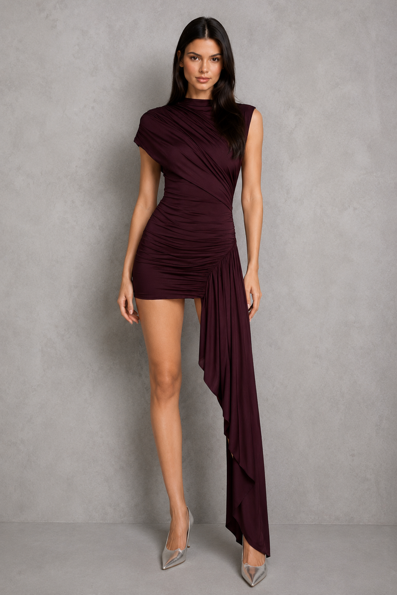 Woman wearing a burgundy dress against a gray background