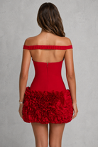 Red off-shoulder dress with floral details on a gray background