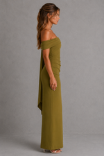 Woman wearing an olive green off-shoulder dress against a gray background