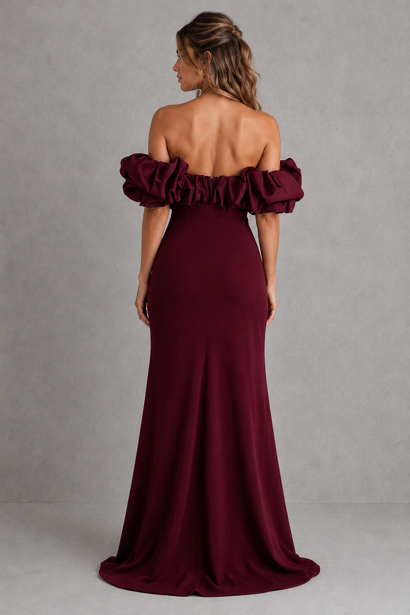 Burgundy off-shoulder gown with ruffled sleeves on a gray background