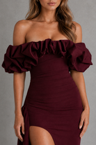 Burgundy off-shoulder dress with ruffled sleeves on a gray background