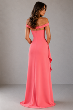 Woman wearing a pink off-shoulder gown against a gray background