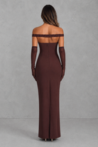 Brown off-shoulder evening gown with long gloves on a gray background