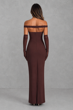 Brown off-shoulder evening gown with long gloves on a gray background