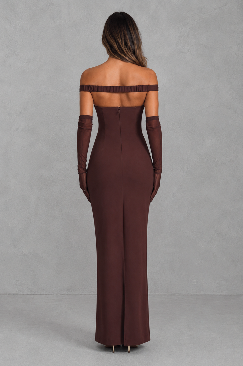 Brown off-shoulder evening gown with long gloves on a gray background