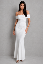 Woman wearing a white off-shoulder gown against a gray background