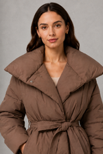 Women’s belted puffer jacket with a quilted design, adjustable waist belt, long sleeves and full front zip fastening.