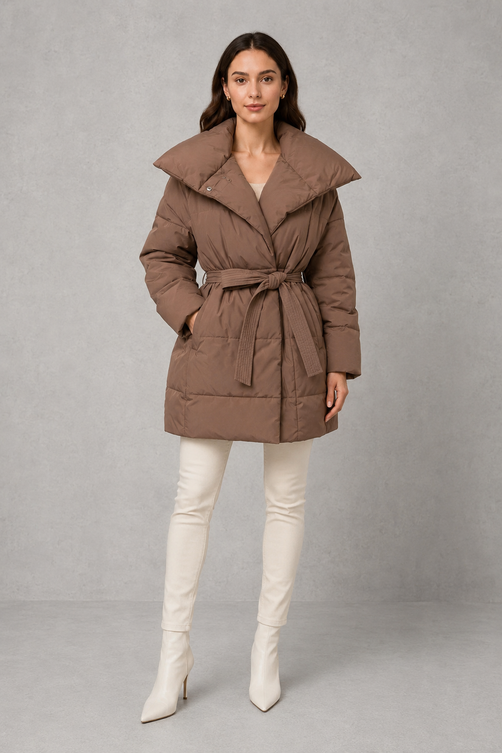 Women’s belted puffer jacket with a quilted design, adjustable waist belt, long sleeves and full front zip fastening.