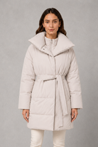 Women’s belted puffer jacket with a quilted design, adjustable waist belt, long sleeves and full front zip fastening.