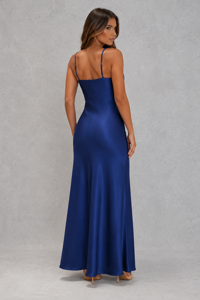 Woman wearing a blue evening gown against a gray background