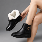 Women's black leather comfort ankle boots with a premium leather upper, soft shearling lining, decorative buckle detail, durable rubber sole and supportive ankle-high design, ideal for everyday autumn and winter wear.
