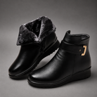 Women's black leather comfort ankle boots with a premium leather upper, soft shearling lining, decorative buckle detail, durable rubber sole and supportive ankle-high design, ideal for everyday autumn and winter wear.