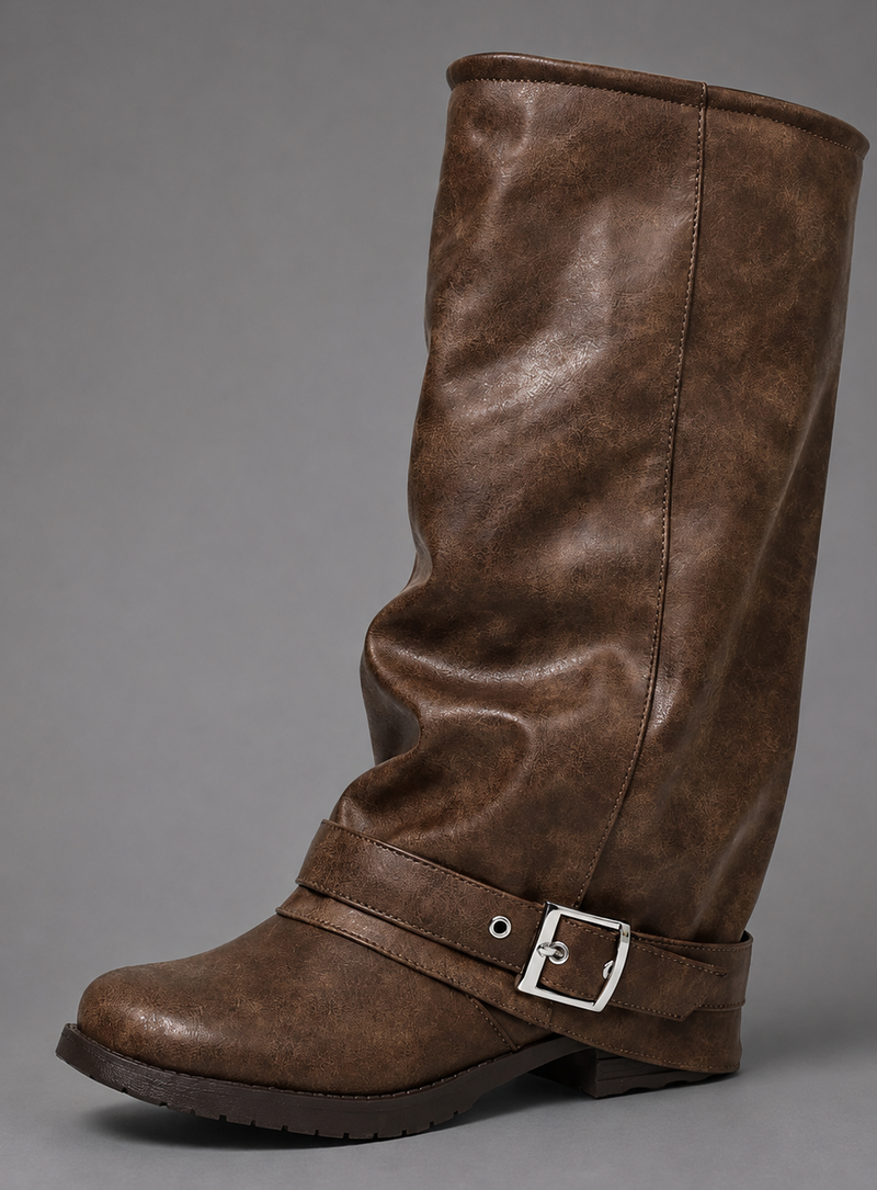 Women’s black slouchy knee-high boots with buckle strap, round toe, low block heel and chunky lug-tread sole.