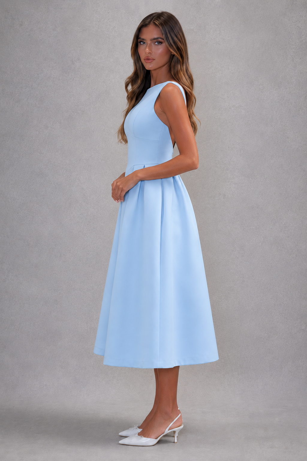 Woman wearing a light blue dress against a gray background