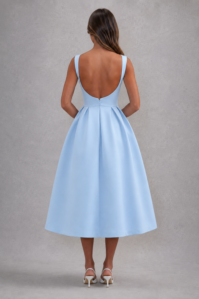 Light blue dress with open back worn by a person on a gray background