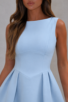Light blue dress worn by a model against a neutral background